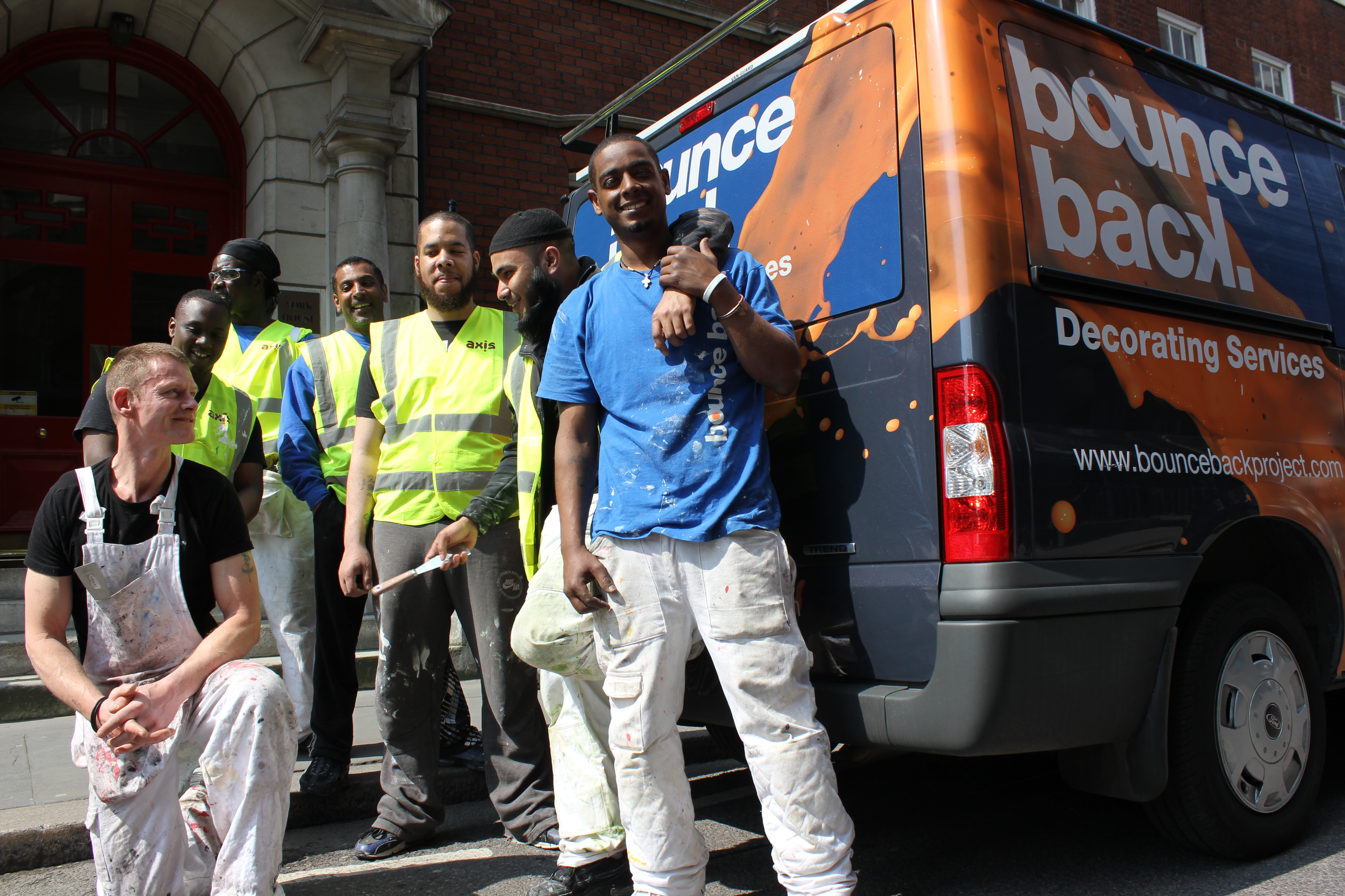 Men standing beside a works van