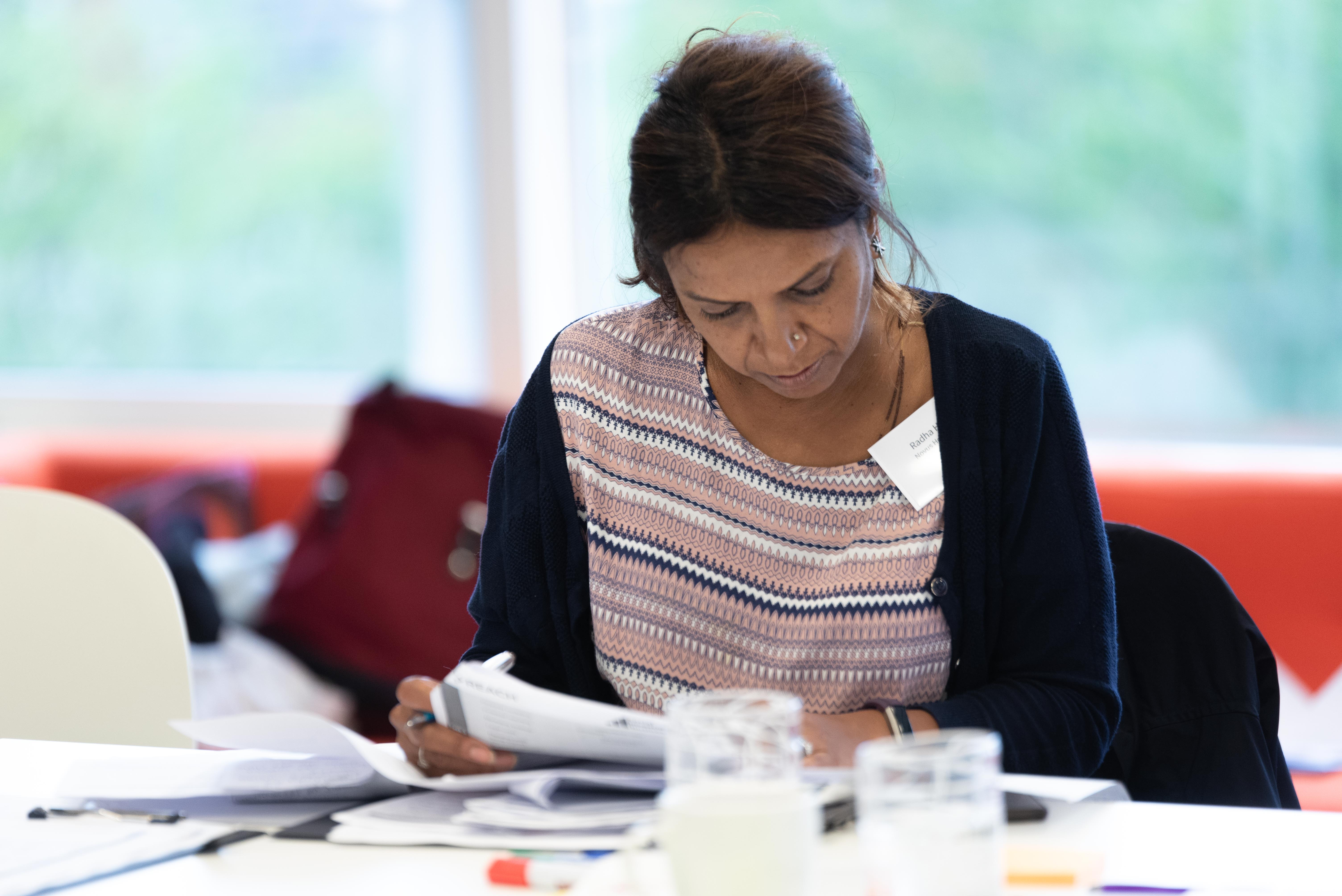 A woman at a desk reading