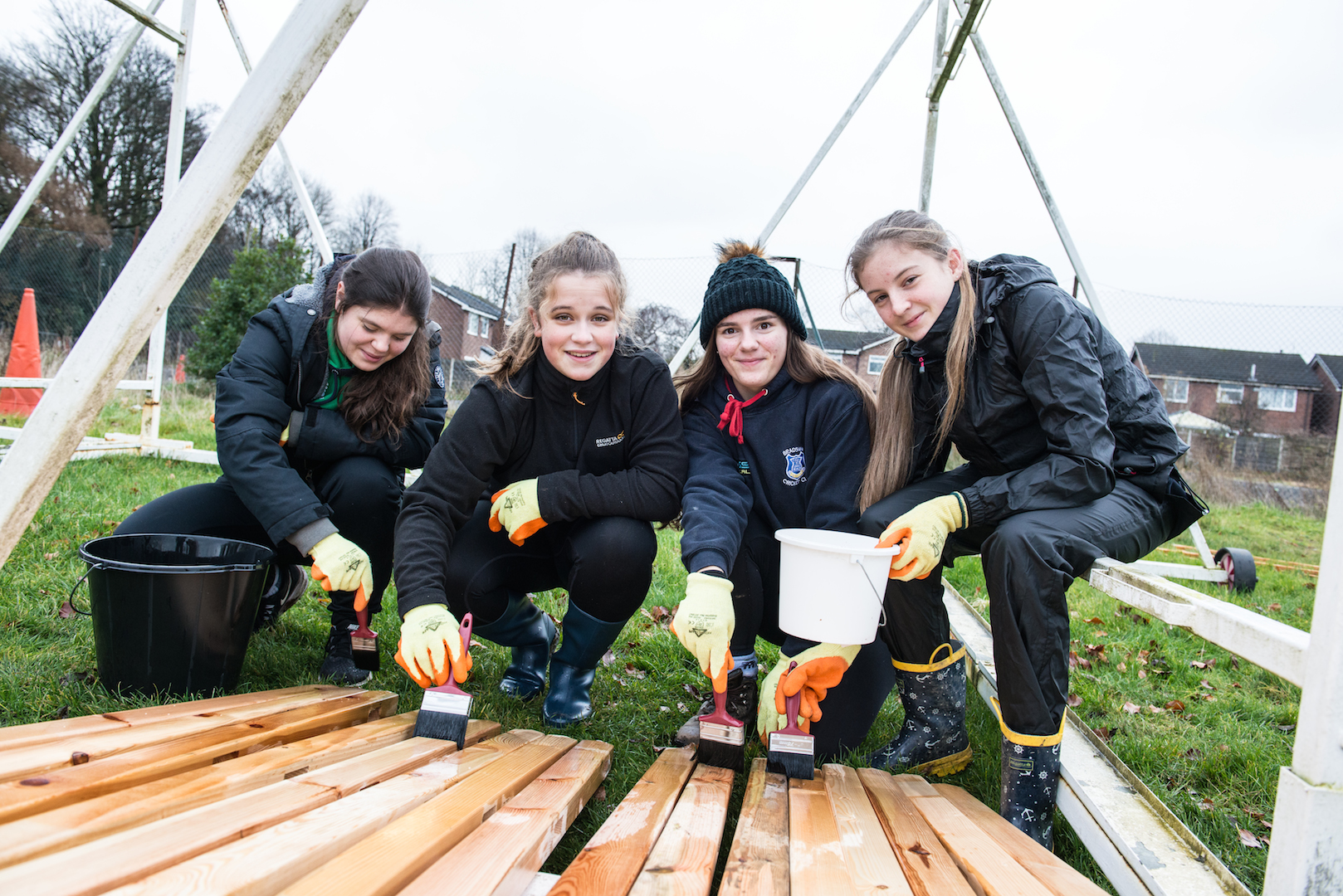 Volunteers varnishing wood